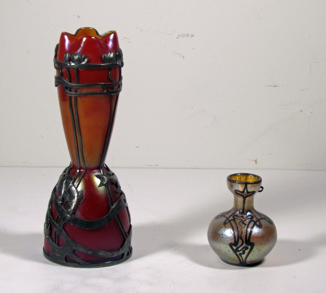Two Loetz Type Vases with Metal Overlay: Title: Two Loetz Type Vases with Metal Overlay, one iridescent with abstract overlay, one cranberry with gold fish and floral overlay Medium: glass, metal Dimensions: tallest measures 11 inches Signat