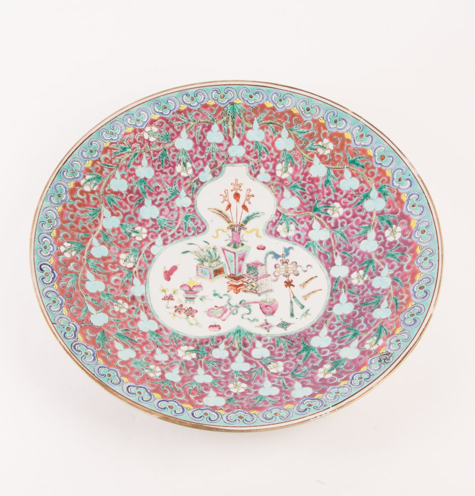Chinese Qing Famille Rose Charger: Title: Chinese Qing Famille Rose Charger. Painted in the center: a medallion with still lifes of Potted plants, fruits, persimmons with abstracted Lotus floral sprays surrounding. Qing Dynasty. Medium