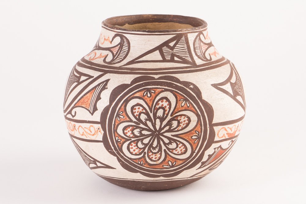 Zuni Pottery Bulbous Vase, Early 20th Century: Title: polychromed red and black over cream slip with two scalloped rosettes, feather elements, cross hatched designs., decorated with a wide geometric border, the body painted with stylized blossoms 
