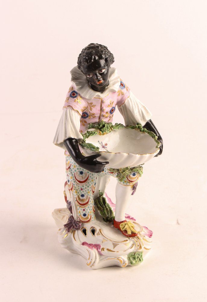 Blackamoor Porcelain Sweetmeat Dish: Title: Kneeling Blackamoor Serving a Porcelain Sweetmeat Dish Medium: glazed porcelain Dimension: 8 x 4 x 5 inches Description: Highly Similar to an example in the Duke of Roxburghe's Ancestral Home P