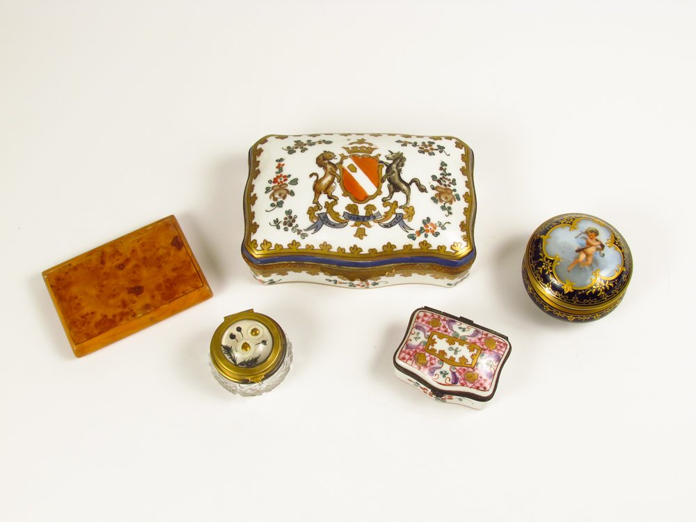 Collection of 5 boxes: Title: Box collection including a Sevres porcelain box with cupid, Sampson porcelain boxes ( one crested with music box), sulphide reverse on glass patch box and a burlwood tobacco box Medium: burlwoo