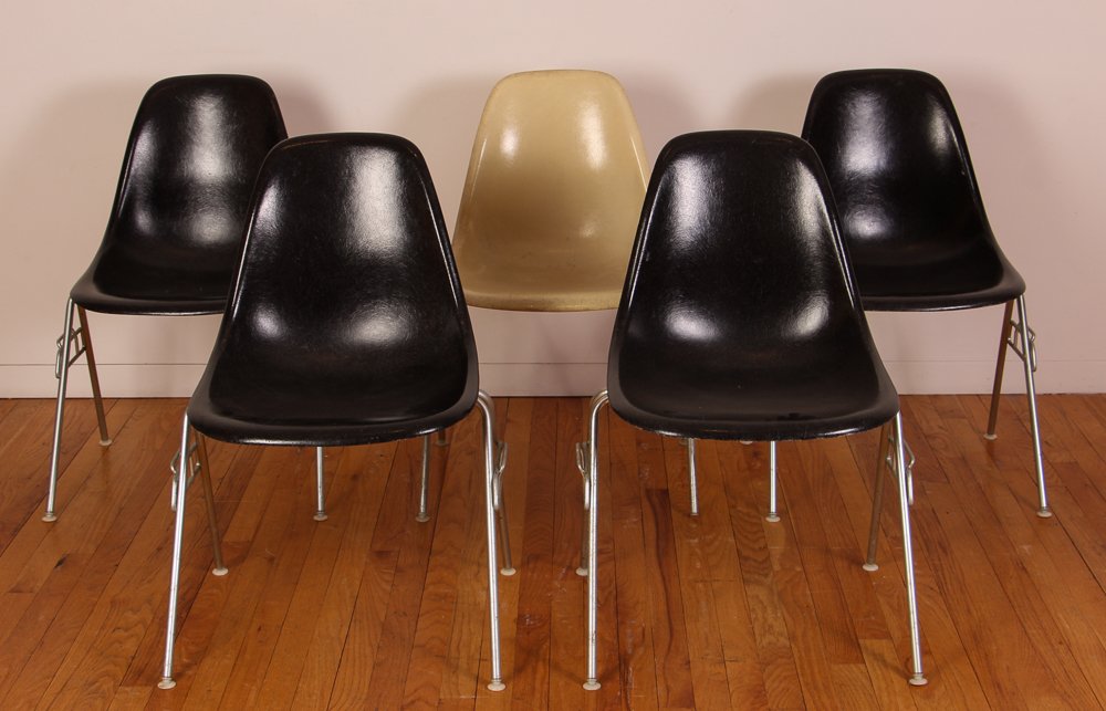 5 Eames Stacking Chairs, 4 black, 1 white: Artist: Eames, Charles and Ray Title: 5 Stacking Shell Chairs Medium: fiberglass Dimension: 31 x 18 x 17 inches Signature: Herman Miller labels on undersides