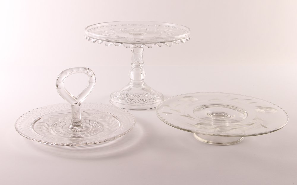 Pair of Glass Cake Plates with Tidbit Tray: Title: Pair of Glass Cake Plates with Tidbit Tray Medium: pressed glass Dimensions: tallest measures: 8 x 10.5 x 10.5 inches Provenance: The Estate of Aaronel Gruber