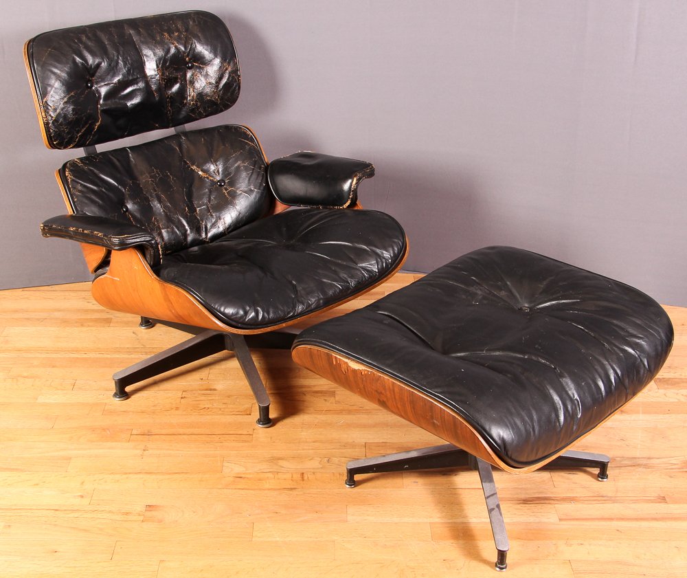 Eames Lounge and Ottoman: Artist Eames, Ray and Charles for Herman Miller Title 670 Lounge and Ottoman Medium black leather Dimensions 32 x 21 x 26 inches (chair) Signature Silver foil Herman Miller label (wi
