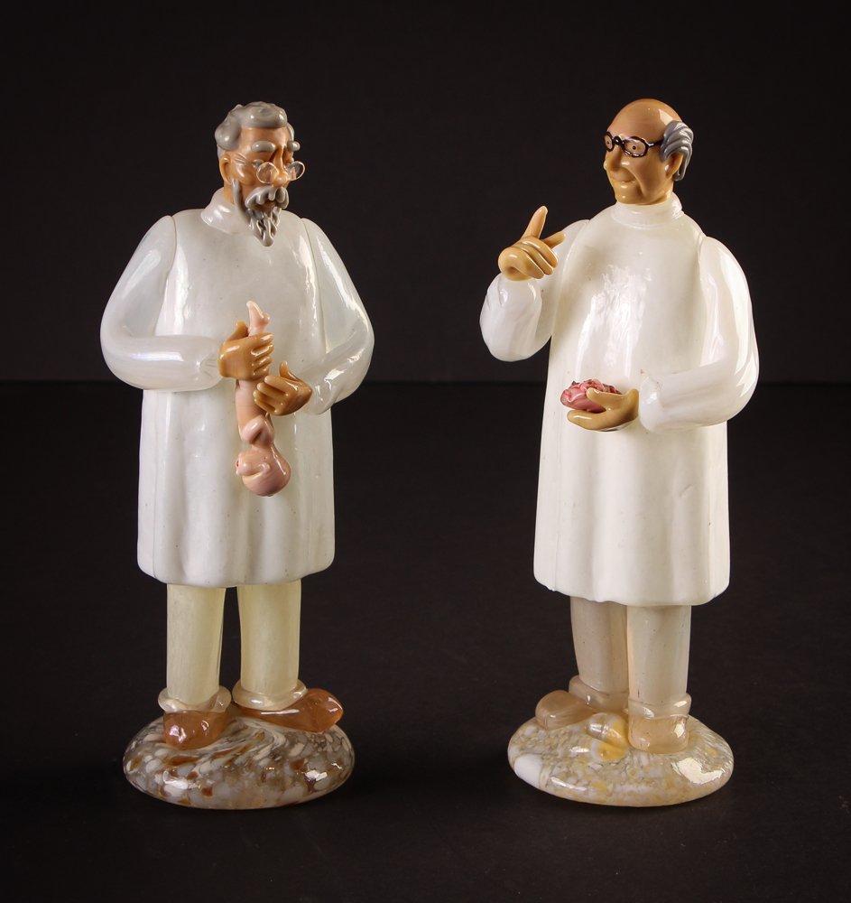 Pair of Murano Glass Doctors: Artist: Barbini, Alfredo Title: Pair of Murano Glass Doctor Figures: One with Brain, One with Infant Medium: Murano Glass Dimensions: 8.5 x 3.25 x 2.75 inches