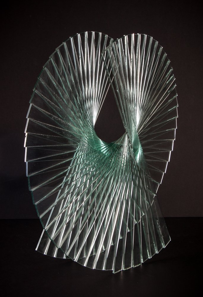 Runstadler glass sculpture "Spiral Motion": Artist: Runstadler, Kurt and Marsha (Contemporary American Glass Artists) Title: Spiral Motion Date: 1985 Medium: glass Dimensions: 22 x 22 x 7 inches Description: "This sculpture was the