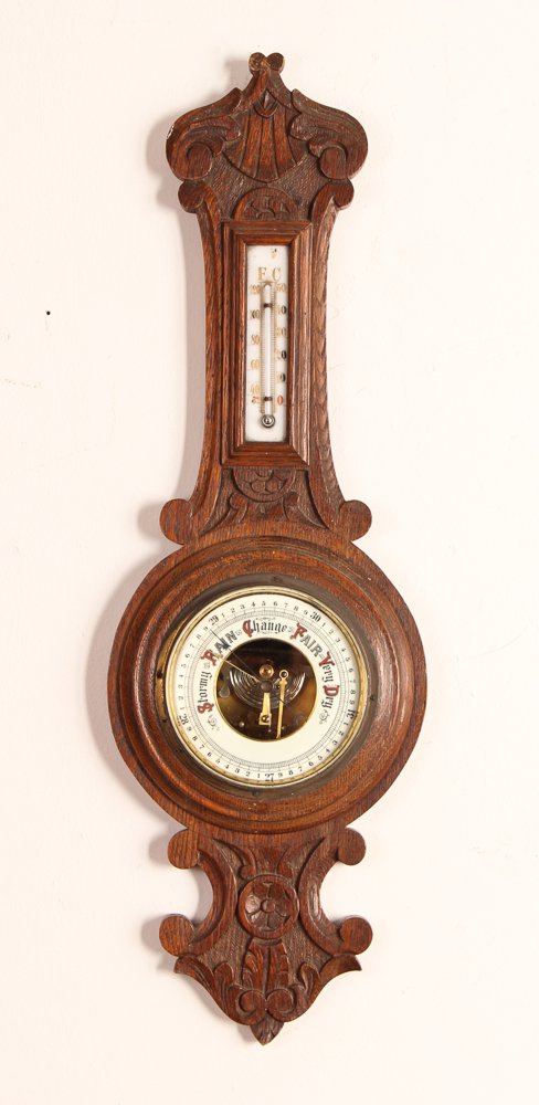 Antique Aneroid Barometer and Thermometer: Title: British Antique Aneroid Carved Oak Barometer with Thermometer Date: 19th Century Medium: oak, brass, glass, mercury Dimensions: 26 x 8.5 x 2.25 inches