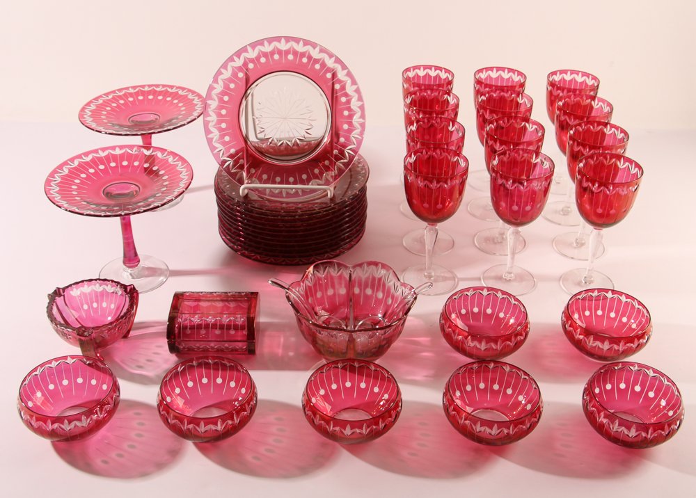 Victorian cranberry glass cut to clear set: Title:12 Plates (8.75 inches in diameter) 7 Bowls (4.5 inches in diameter) 2 Compotes (6.5 inches Tall), 12 wine glasses (7.5 inches tall), sauce bowl, bowl, lidded box Medium:cranberry glass