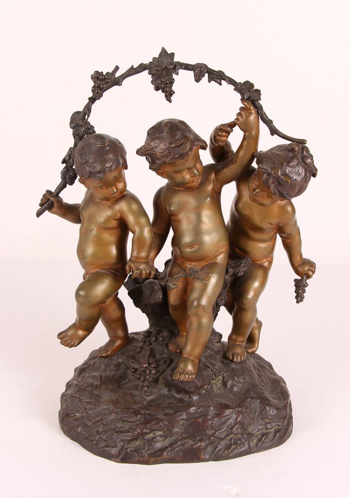 Auguste Moreau Three Children Bronze: Moreau, Auguste (French, 19th Century) bronze of three infants with a garland of grapevine, signed on reverse, 11 x 7 x 14 inches.