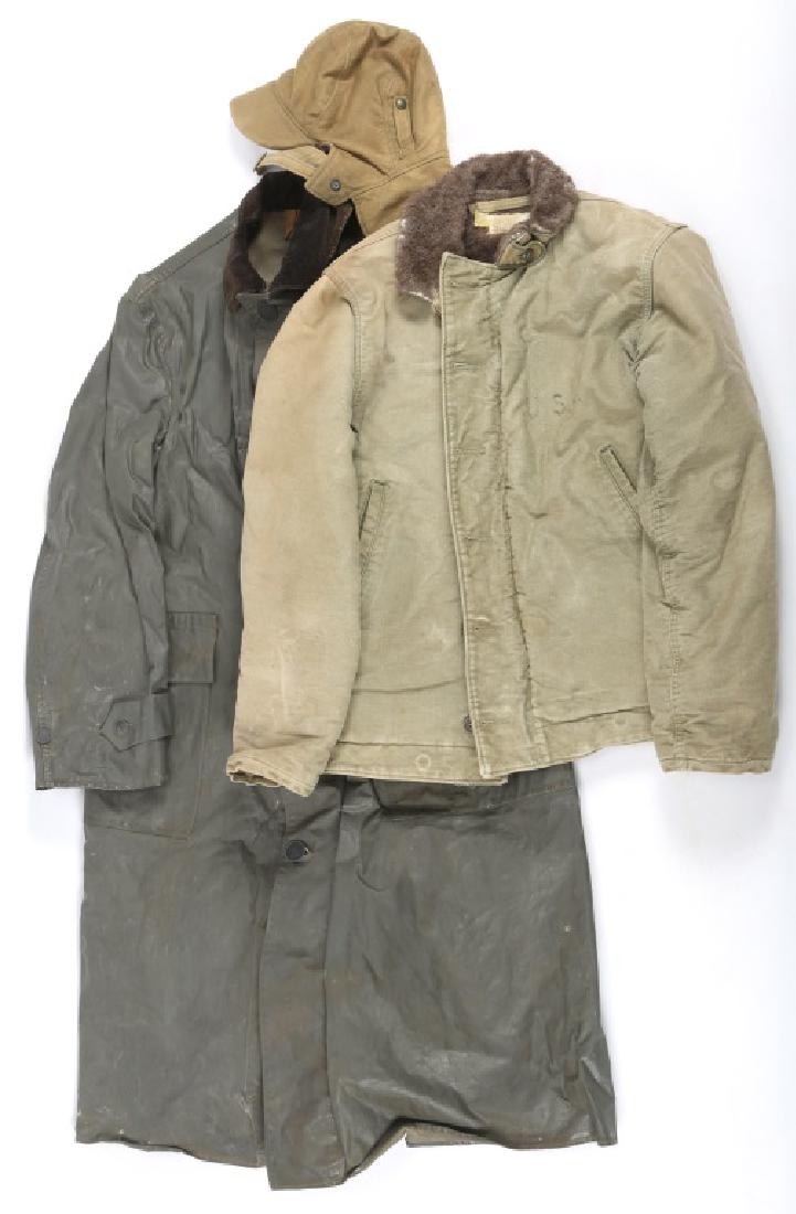 WWII US NAVY COLD WEATHER JACKET AND RAINCOAT LOT: WWII US NAVY COLD WEATHER JACKET AND RAINCOAT LOT USN cold weather deck jacket and hat. Rubberized raincoat.