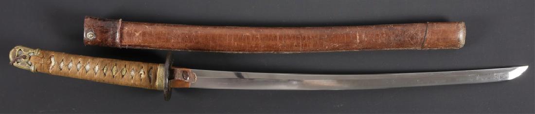 WWII JAPANESE WAKIZASHI WITH KAI-GUNTO MOUNTS: WWII JAPANESE WAKIZASHI WITH KAI-GUNTO MOUNTS A wakizashi, unsigned blade. Silk bound military mounts with gold shakudo menuki and circular iron tsuba moulded with a dragon above foaming waves. Black 