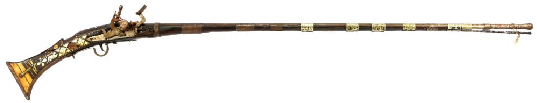 MIDDLE EASTERN BONE INLAY SNAPHAUNCE MUSKET: MIDDLE EASTERN BONE INLAY SNAPHAUNCE MUSKET 63" overall. Octagon to round barrel. Checkered bone inlay with brass and silver color tacks. Engraved brass and silver colored barrel bands. Caliber / Gaug