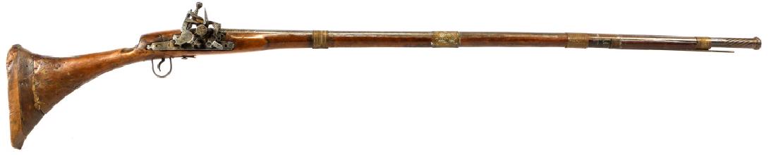 MIDDLE EASTERN 75 CALIBER SNAPHAUNCE MUSKET: MIDDLE EASTERN 75 CALIBER SNAPHAUNCE MUSKET Ribbed round barrel with gold color paint on top of barrel near lockplate. Twist design on barrel near the muzzle. Finely engrave brass barrel bands. 60" ov