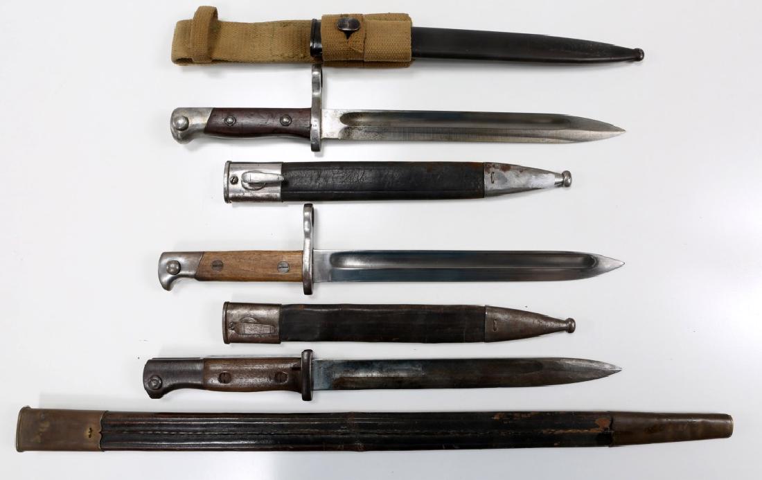 WWI GERMAN MADE MAUSER BAYONET LOT: WWI GERMAN MADE MAUSER BAYONET LOT Three bayonets and extra long 22.5" leather scabbard. German short S98 bayonet, double stamped with Mfg maker and distributor marks, blade size 9.75", overall size 1