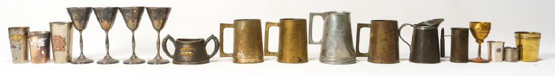 US MILITARY AND SOUVENIR CUPS LOT OF 17: US MILITARY AND SOUVENIR CUPS LOT OF 17 5 trench art cups, 7 souvenir cups, 4 wine glasses and 1 small pitcher. Size: 2.25" - 6.25"