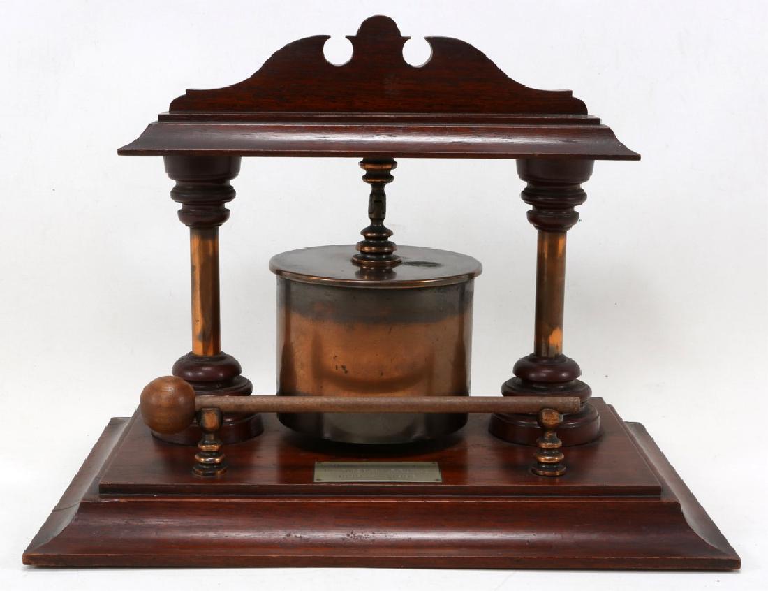 BOER WAR SHELL ART HOWITZER CARTRIDGE BELL: BOER WAR SHELL ART HOWITZER CARTRIDGE BELL Bell on wooden stand with mallet. Engraved plaque marked "5" Howitzer Cartridge Case "Captured from the Boers 1899-1902". Case marked "Berndorf 1896". Size: