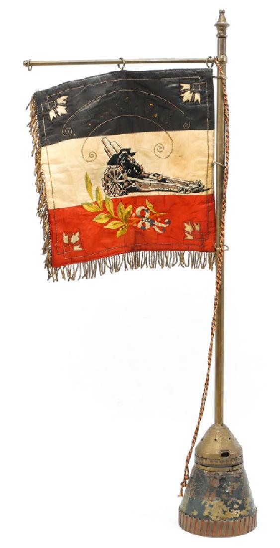 WWI IMPERIAL GERMAN HEAVY ARTILLERY FLAG: WWI IMPERIAL GERMAN HEAVY ARTILLERY FLAG One side depicting heavy artillery over Imperial German flag. Reverse side stitched "Schwere Artillerie" over "1930". Projectile base stamped "Dopp.Z.92.f.10cm