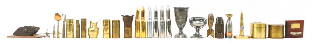 WWI SOUVENIR TRENCH ART LOT OF 27: WWI SOUVENIR TRENCH ART LOT OF 27 WWI souvenir trench art including commemorative 20mm rounds, desk display pieces, engraved shells, and two engraved shell containers. One display plaque inscribed "BA