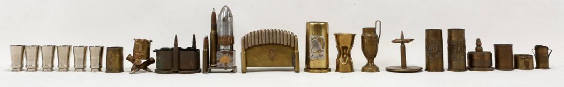WWI SHELL TRENCH ART TABLE TOP ITEMS LOT OF 19: WWI SHELL TRENCH ART TABLE TOP ITEMS LOT OF 19 Set of 5 shot glasses, marked "38 135F P181" on bottom, ashtray made from 10mm and 40mm shell casing, desk box, "Verdun" napkin ring, 7 small WWI engrave