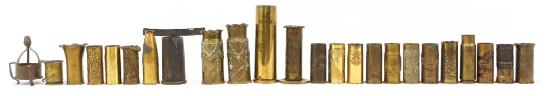 WORLD TRENCH ART SHELL VASE LOT OF 24 WITH ASHTRAY: WORLD TRENCH ART SHELL VASE LOT OF 24 WITH ASHTRAY Mostly WWI and WWII era shell art vases from various countries. Markings include "Verdun", "USN", "Reims", "Ypres", "Albert", "Bat C 147 FA", "Souven