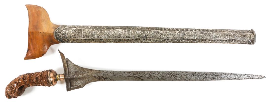 19th CENTURY INDONESIAN SUMATRA KRIS LURUS: 19th CENTURY INDONESIAN SUMATRA KRIS LURUS Indonesian kris sword and silver repousse scabbard. Copper and gold alloy collar around hilt. Floral and wave pattern. Blade Length: 13.5" Overall Length: 17