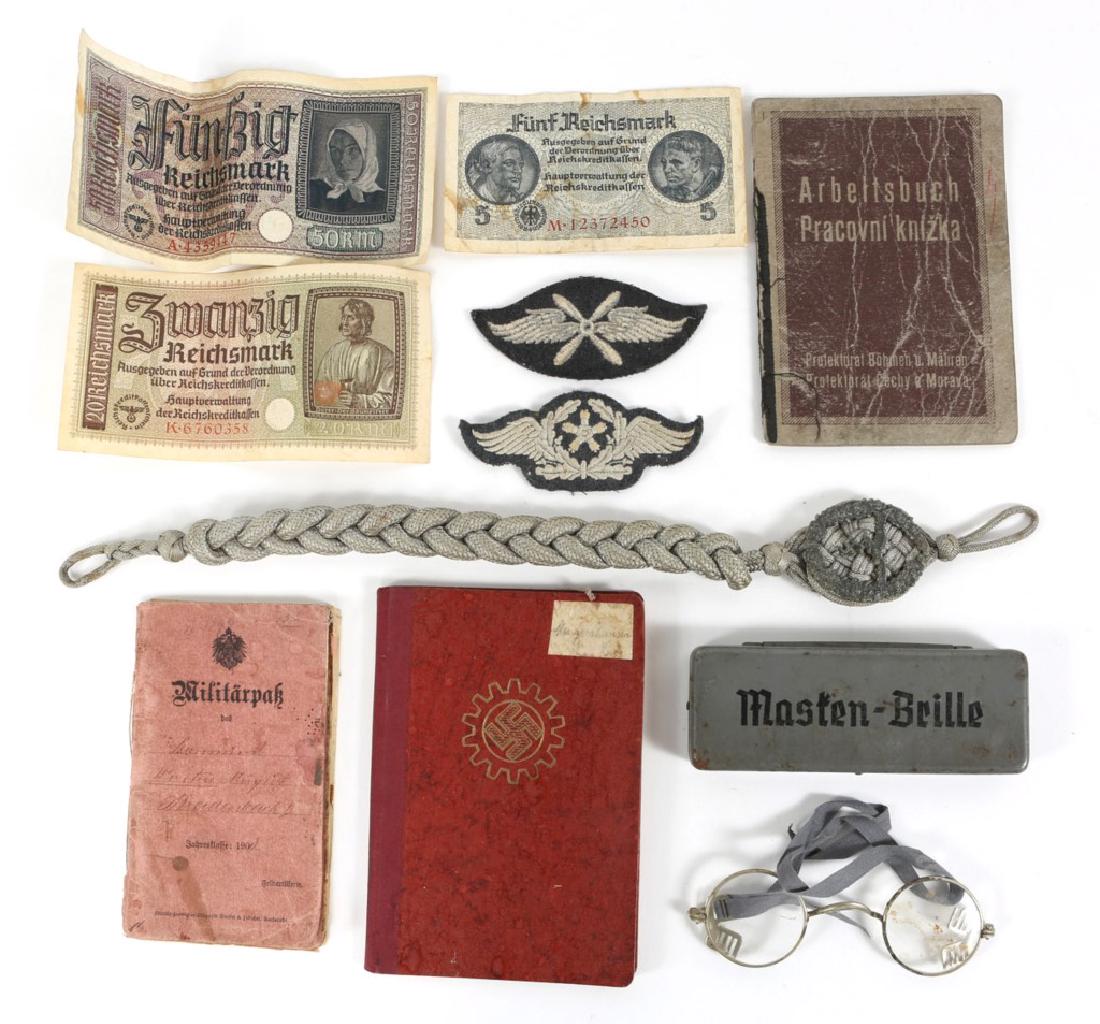 WWII GERMAN MIXED ITEM LOT: WWII GERMAN MIXED ITEM LOT Includes Masten-Brille gas mask glasses in original case, German Labour Front member booklet, 2 WWII German currency bills, silver Luftwaffe marksmanship lanyard, measures 1