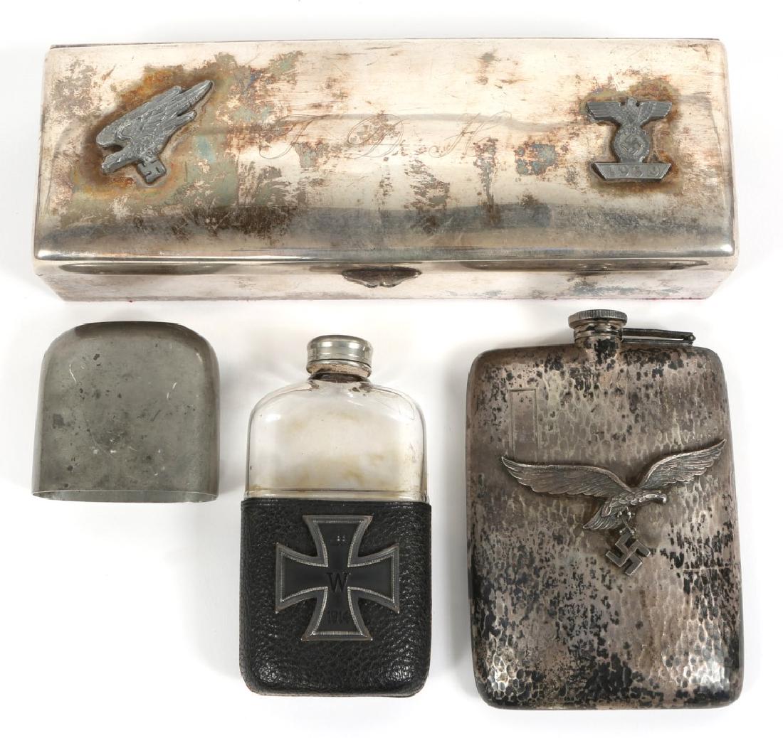 WWII GERMAN LUFTWAFFE FLASK & CIGARETTE BOX: WWII GERMAN LUFTWAFFE FLASK & CIGARETTE BOX A World War II German silver hip flask with large applied silver Falschirmjager (parachutist) device over swastika. Monogram plate unengraved. Screw top lid