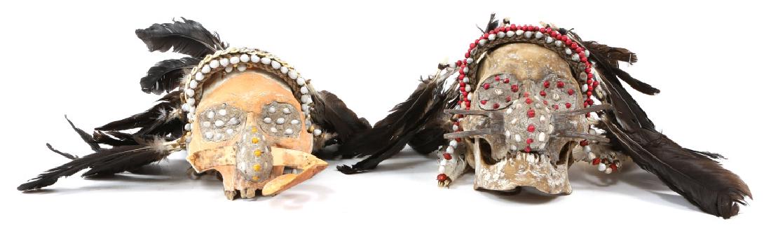 ASMAT TROPHY SKULL MODEL LOT OF 2: ASMAT TROPHY SKULL MODEL LOT OF 2 Two resin models of human trophy skulls decorated in the style of the Asmat people of New Guinea. Size: 8" X 7"