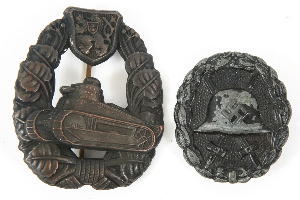 WWII GERMAN WOUND & TANK ASSAULT BADGE LOT OF 2: WWII GERMAN WOUND & TANK ASSAULT BADGE LOT OF 2 German World War II Black Condor Legion Wound Badge. The front shows a German helmet in the center with a pair of crossed swords in the back ground. All