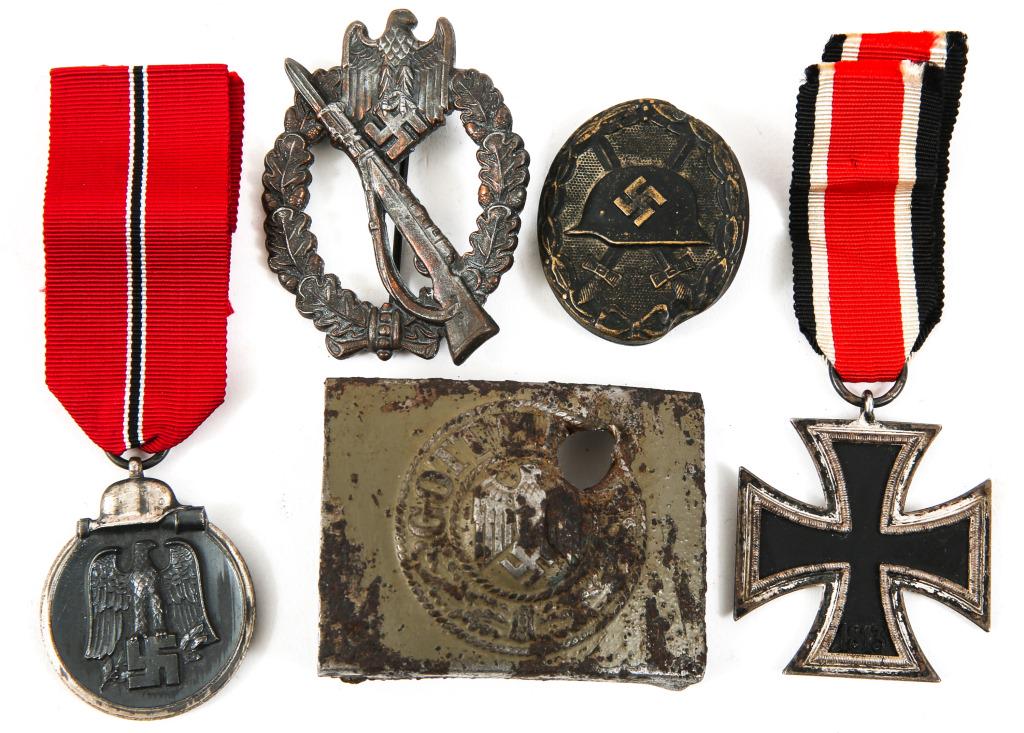 WWII GERMAN ARMY MEDAL BADGE AND BUCKLE LOT: WWII GERMAN ARMY MEDAL BADGE AND BUCKLE LOT WWII German memorabilia lot of 5. Includes Iron Cross 2nd class, no maker mark; Eastern Front Medal; Wound badge ( damaged ), relic belt buckle; Infantry As