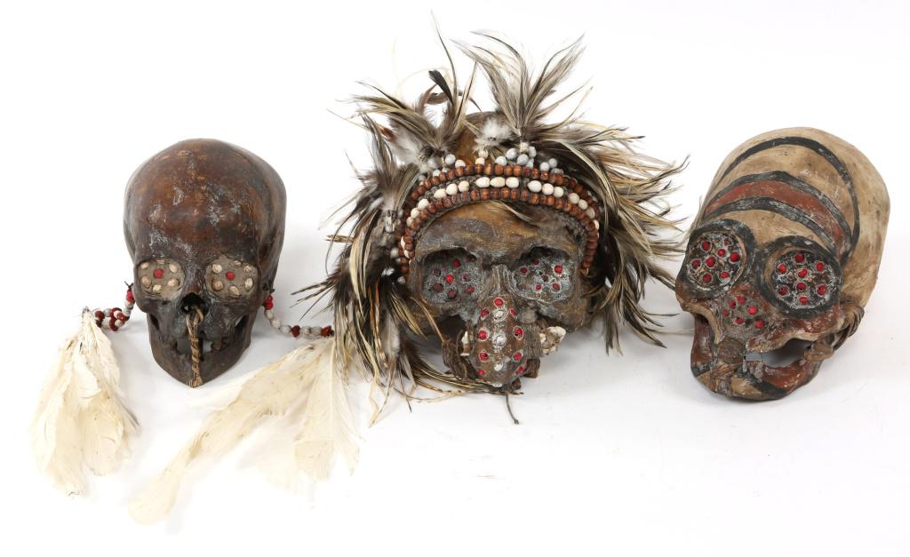 ASMAT TROPHY SKULL MODEL LOT OF 3: ASMAT TROPHY SKULL MODEL LOT OF 3 Three resin models of human trophy skulls decorated in the style of the Asmat people of New Guinea. Size: 8" X 7"