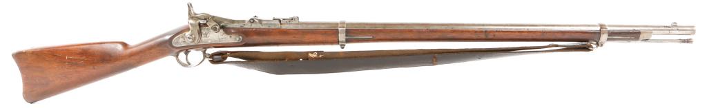 US SPRINGFIELD MODEL 1863 TRAPDOOR CONVERSION: US SPRINGFIELD MODEL 1863 TRAPDOOR CONVERSION U.S. Springfield Model 1863 converted to a Model 1869 Trapdoor. 52" total length. Barrel Length 32". Caliber is .50. Multiple cartouches on left side, som