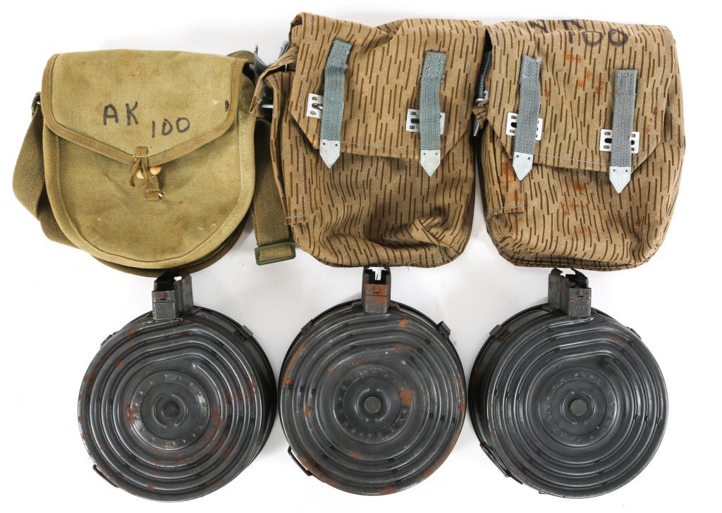 CHINESE AK-47 100RD DRUM MAGAZINE IN POUCH LOT: CHINESE AK-47 100RD DRUM MAGAZINE IN POUCH LOT 2 Chinese unmarked 100rd AK-47 7.62x39mm drum magazines, in rain pattern camouflage pouches. 1 Chinese Norinco 100rd AK-47 7.62x39mm drum magazine (stamp