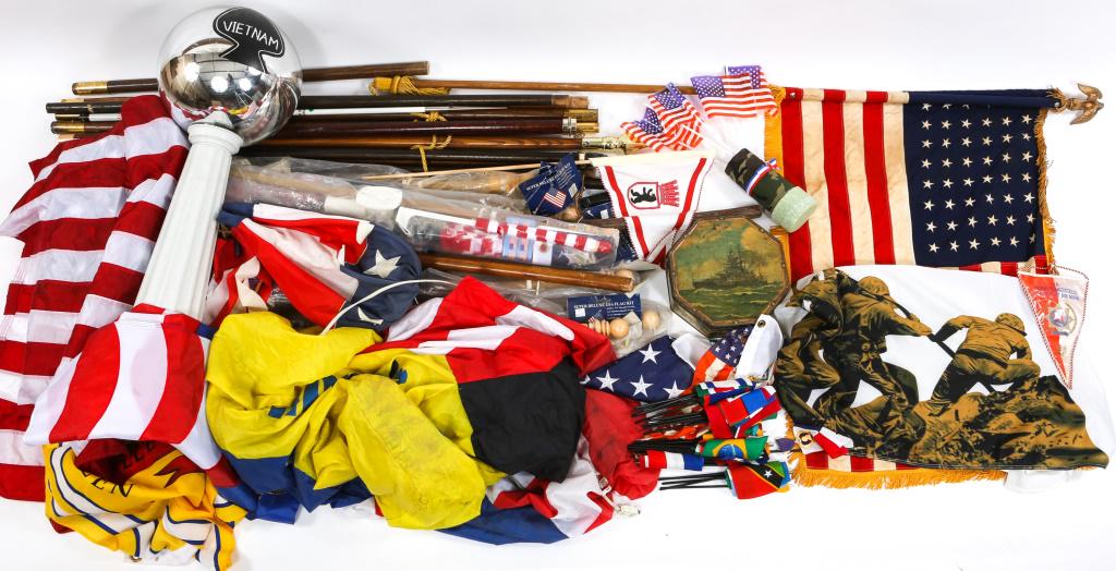 FLAG AND FLAG POLE LARGE LOT: FLAG AND FLAG POLE LARGE LOT Large lot of flags, flag poles, "Support our troops" inflatable banner with working fan, painted Vietnam lawn decoration, and wooden walking sticks.