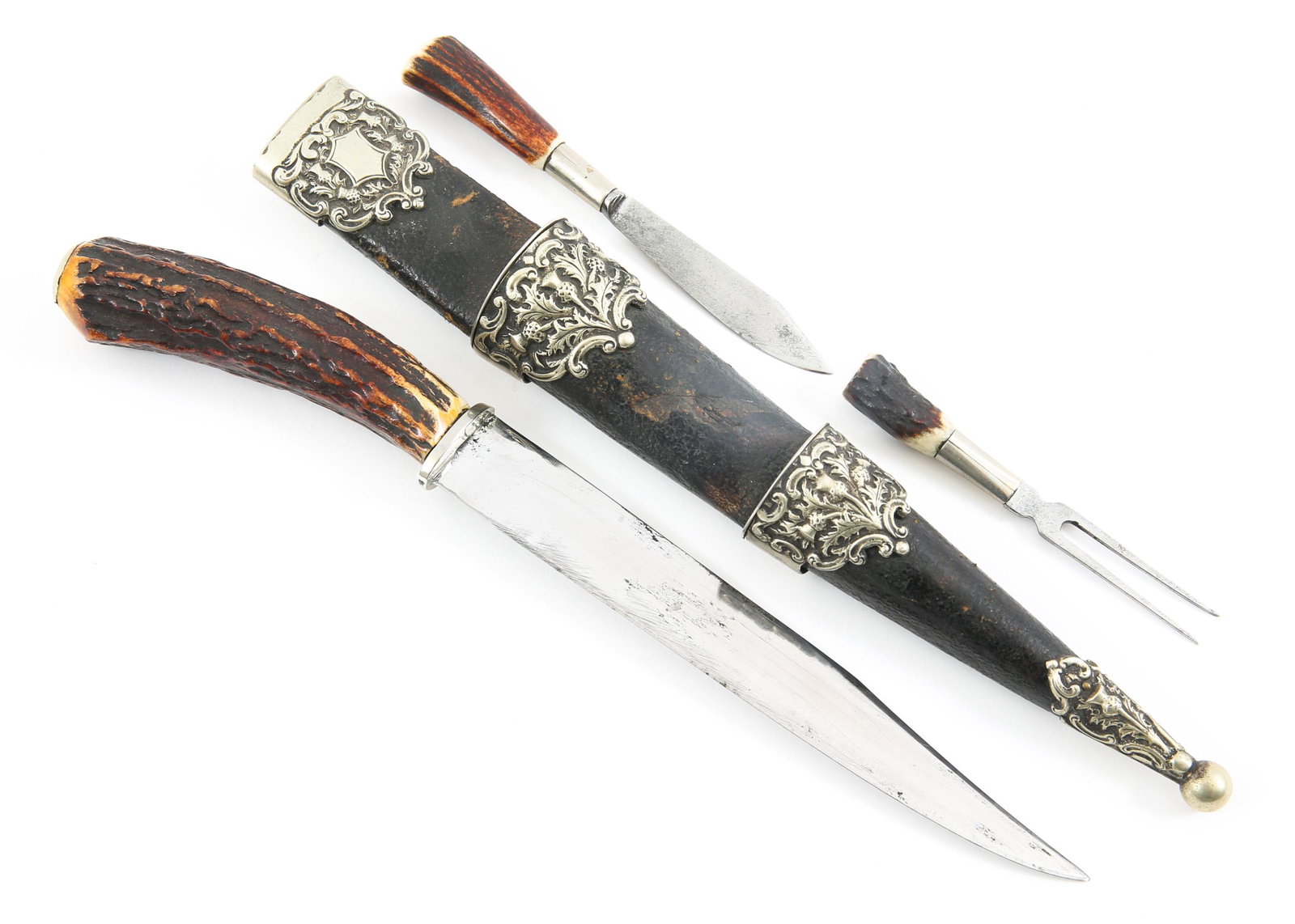 SCOTTISH HIGHLAND SGIAN DUBH STAG HANDLE KNIFE SET: SCOTTISH HIGHLAND SGIAN DUBH STAG HANDLE KNIFE SET 19th or 20th Century knife set with silver fittings, hallmarked. Stag handles, with black leather covered scabbard. Primary knife is edged with a cli
