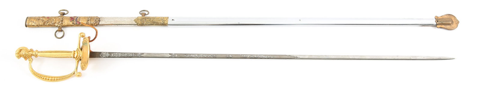 BRITISH ER II PRESENTATION SWORD MASONIC SCABBARD: BRITISH ER II PRESENTATION SWORD MASONIC SCABBARD Late 20th Century British ER II presentation sword with decoratively etched double edged blade. Red leather buffer pad present, with knights head pomm