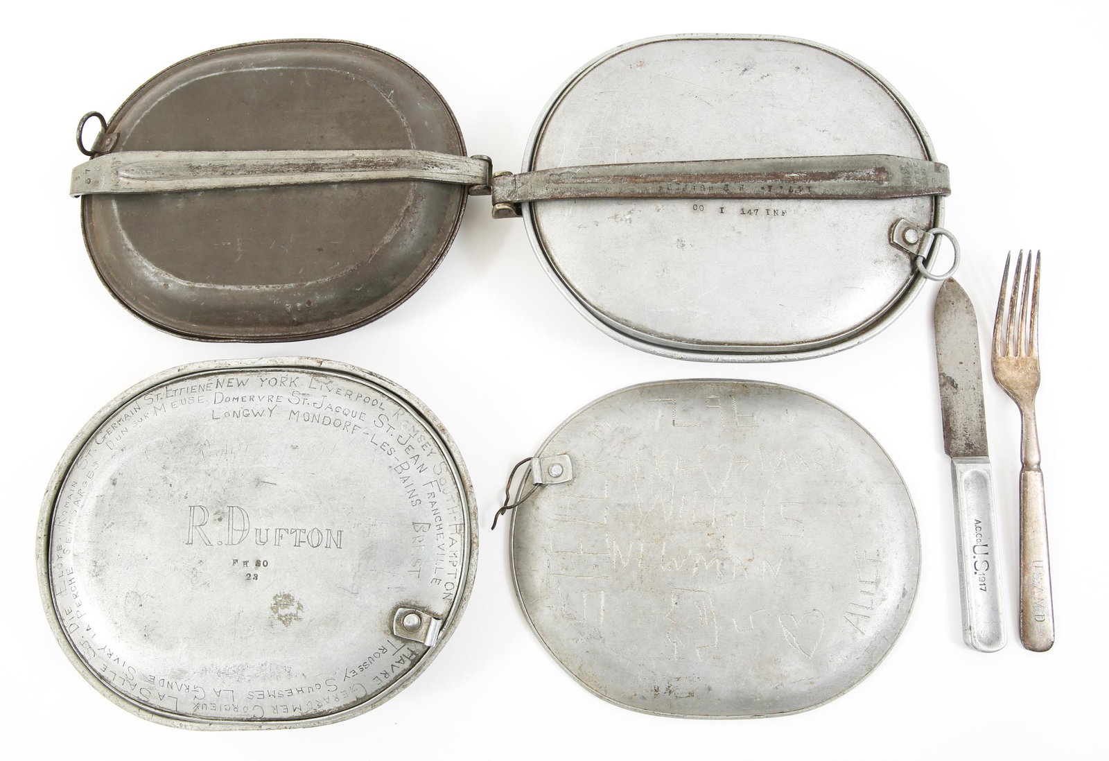 WWI US ARMED FORCES MESS KITS & FLATWARE LOT: WWI US ARMED FORCES MESS KITS & FLATWARE LOT WWI US armed forces flatware & mess kits, lids are marked with wartime etching of names, cities and more. Marked " US 1917 " on retainer rod. Fork engraved