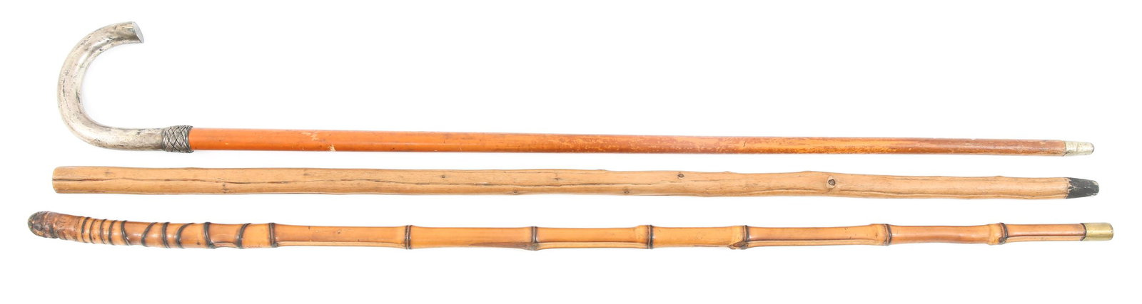 WOODEN WALKING STICKS - LOT OF 3: WOODEN WALKING STICKS - LOT OF 3 Lot of 3 wooden walking sticks. One has an 800 silver handle with a woven pattern and engraved with “V. Hinckeldey.” Lengths are approximately 34.5” and 35” (2