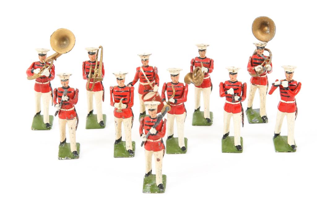 BRITISH RED COAT BAND & US MARINE CORPS MINIATURES: BRITISH RED COAT BAND & US MARINE CORPS MINIATURES USMC in full marching dress uniforms, one holding USMC flag. marked "TEDTOY" on base. Mounted. British Red Coats marching band in full dress uniforms