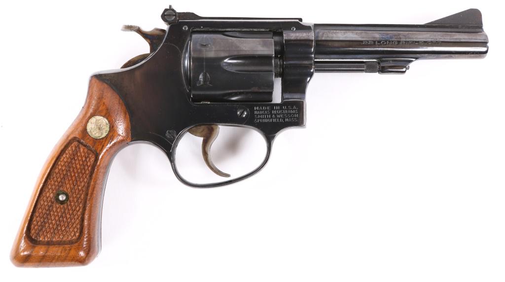 SMITH & WESSON MODEL 34-1 .22 LR REVOLVER: SMITH & WESSON MODEL 34-1 .22 LR REVOLVER Smith & Wesson Model 34-1 .22 LR Double Action Revolver. The lot includes the original box and manual. The revolver features blued finish, checkered walnut gr