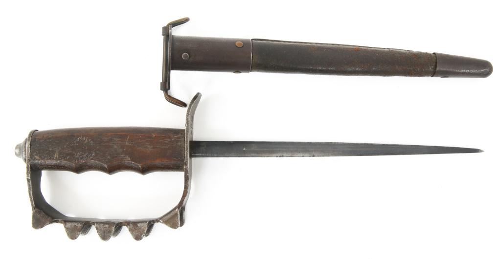 WWI US ARMY M1917 TRENCH KNIFE By O.C.L 1918: WWI US ARMY M1917 TRENCH KNIFE By O.C.L 1918 WWI US Army AEF Model 1917 trench / knuckle knife, stamped under the guard " U.S , O.C.L 1918 ". Dark green leather scabbard with steel fittings. Dark waln