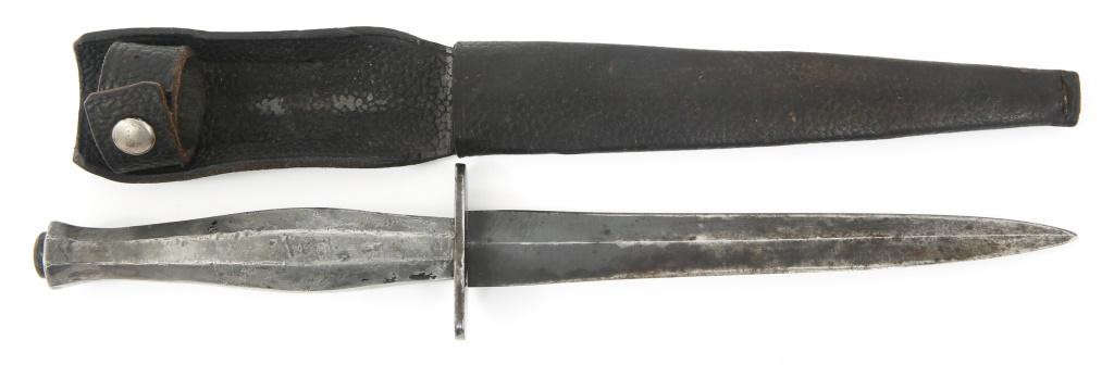 WWII FAIRBAIRN SYKES FIGHTING KNIFE WITH SHEATH: WWII FAIRBAIRN SYKES FIGHTING KNIFE WITH SHEATH WWII British Fairbairn Sykes Fighting Knife accompanied by Black Leather Sheath. Unmarked. Early variant. Blued blade, sharp edge. 2 inch Oval Guard. Oc