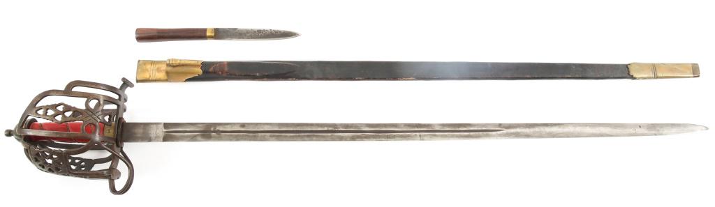 SCOTTISH HIGHLAND THEATER BROADSWORD WITH SCABBARD: SCOTTISH HIGHLAND THEATER BROADSWORD WITH SCABBARD Modern Production Tourist / Theater Scottish Highland pierced basket hilted broadsword. Basket hilt decorated with traditional pierced heart pattern.