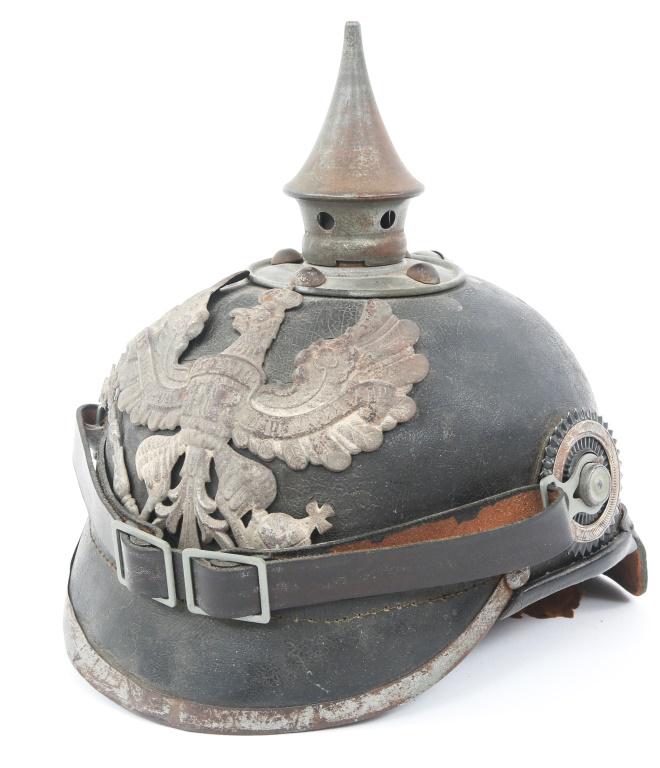 WWI GERMAN M1915 PRUSSIAN PICKELHAUBE HELMET: WWI GERMAN M1915 PRUSSIAN PICKELHAUBE HELMET WWI Imperial German Model 1915 Prussian Pickelhaube. With chinstrap, left & right colored cockades, spike, as well as frontal insignia. 8 - finger interior
