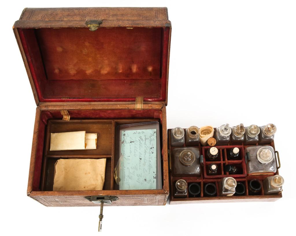 BOXED LEATHER APOTHECARY MEDICAL KIT WITH KEY: BOXED LEATHER APOTHECARY MEDICAL KIT WITH KEY Boxed leather apothecary medical solution kit with key. Box measures 11" by 9" by 7.5". Locking box includes original key. Red felt lining. Period glass a