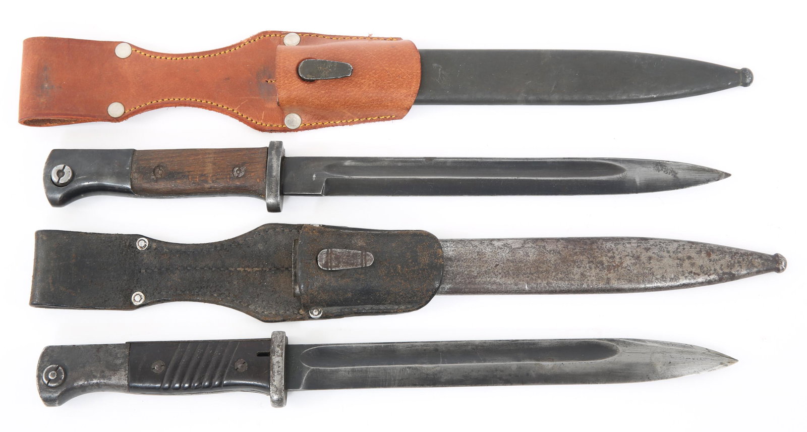 WWII GERMAN K98 COMBAT BAYONET & SCABBARD LOT OF 2: WWII GERMAN K98 COMBAT BAYONET & SCABBARD LOT OF 2 WWII German K98 combat bayonets with scabbards and frogs, lot of 2. (1) Matching serial numbers. Blade still has original bluing. Marked ricasso. Bak