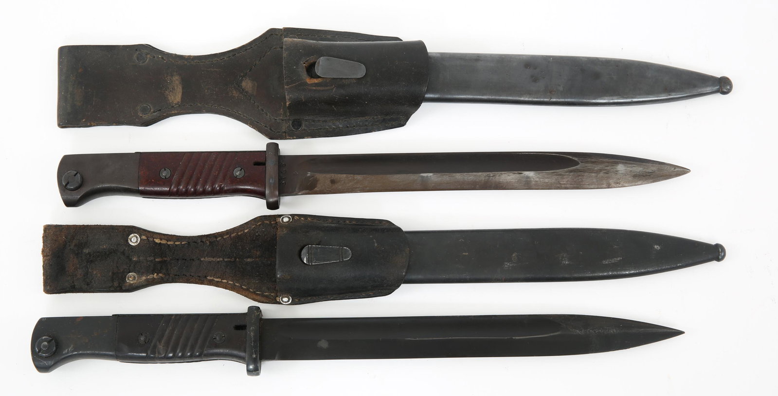 WWII GERMAN K98 COMBAT BAYONET & SCABBARD LOT OF 2: WWII GERMAN K98 COMBAT BAYONET & SCABBARD LOT OF 2 WWII German K98 combat bayonets accompanied by scabbards and frogs, lot of 2. (1) Matching serial numbers. Blade still bears original bluing. Marked 