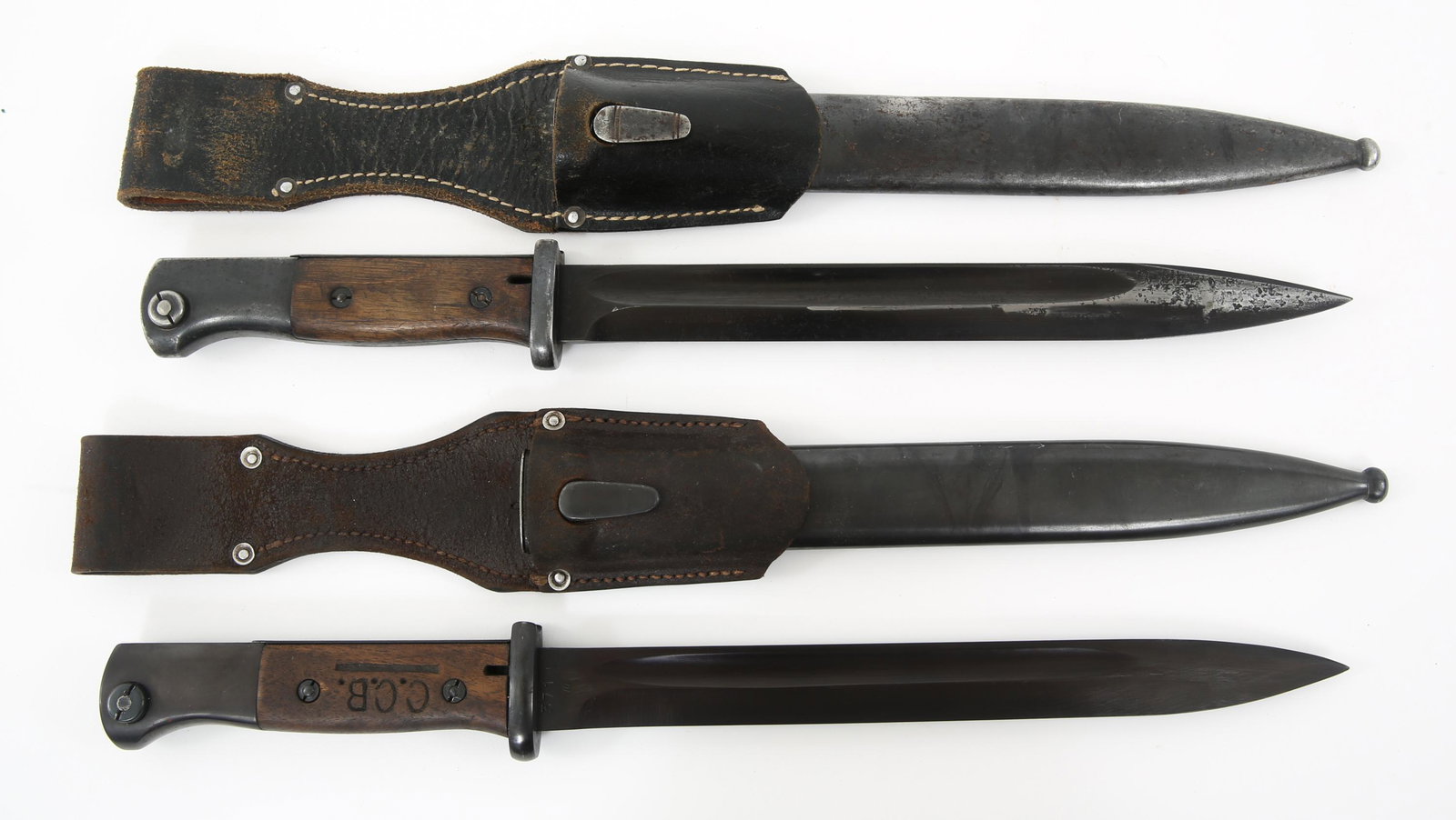 WWII GERMAN K98 COMBAT BAYONET & SCABBARD LOT OF 2: WWII GERMAN K98 COMBAT BAYONET & SCABBARD LOT OF 2 WWII German K98 combat bayonets accompanied by scabbards and frogs, lot of 2. (1) Matching serial numbers. Blade still has original bluing and exhibi