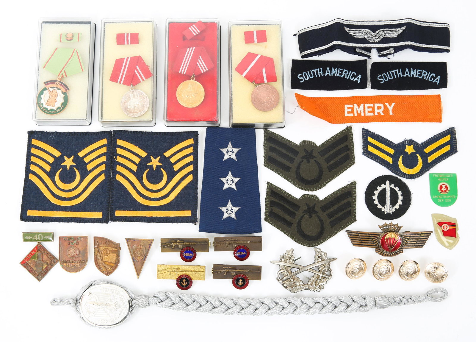 20TH CENTURY WORLD MILITARY MEDALS PINS & PATCHES: 20TH CENTURY WORLD MILITARY MEDALS PINS & PATCHES Mixed lot of 20th Century East German, Spanish, and Turkish military items. Lot includes: 4 boxed East German Medals, Marksmanship pins, Rank Insignia