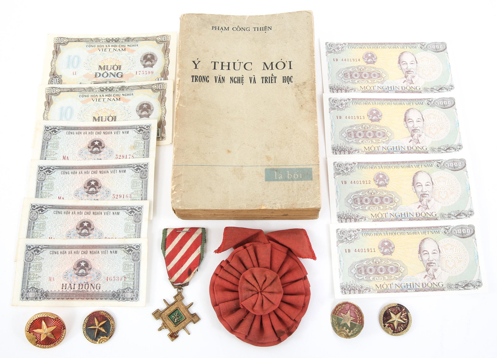 VIETNAMESE AWARDS MEDALS BOOK & CURRENCY LOT: VIETNAMESE AWARDS MEDALS BOOK & CURRENCY LOT Vietnamese Awards, Medals, Pins, Book and Currency lot. Book titled "New Consciousness" by the Poet Pham Cong Thien (1941-2011). Book is signed in the insi